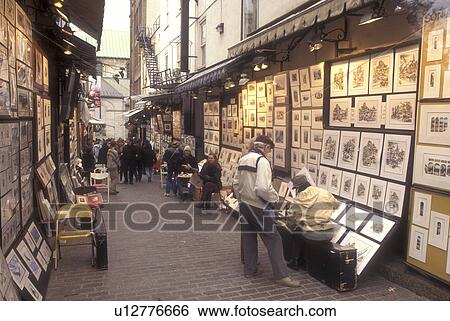 Stock Photograph -  Canada, Quebec, Street artists display their art work on Rue du Tresor in Old Quebec City., . Fotosearch