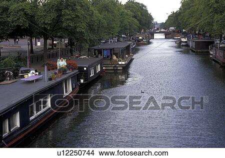canal, Amsterdam, Holland, Netherlands, Europe, House boats along a canal in downtown Amsterdam. View Large Photo Image Picture - canal, Amsterdam, Holland, Netherlands, Europe, House boats along a canal in downtown Amsterdam.. Fotosearch