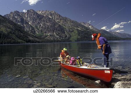canoe, Grand Teton National Park, Lake Jenny, Grand Teton, Grand Teton Mountain, Wyoming, Rocky Mountains, A family wearing lifejackets gets ready to paddle their red canoe on Lake Jenny in Grand Teton National Park in the state of Wyoming. View Large Photo Image Stock Photograph - canoe, Grand Teton National Park, Lake Jenny, Grand Teton, Grand Teton Mountain, Wyoming, Rocky Mountains, A family wearing lifejackets gets ready to paddle their red canoe on Lake Jenny in Grand Teton National Park in the state of Wyoming. . Fotosearch