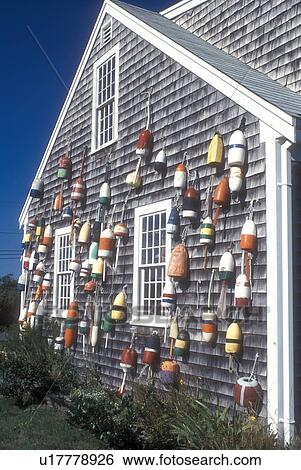 Stock Photograph -  Cape Cod, Massachusetts, Colorful fishing buoys hanging from the side of a house in North Truro, Massachusetts. . Fotosearch