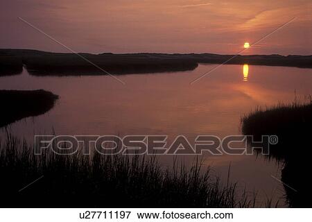 Cape Cod, Sandwich, Massachusetts, Atlantic Ocean, The sunrises over the inlet. View Large Photo Image Stock Photo - Cape Cod, Sandwich, Massachusetts, Atlantic Ocean, The sunrises over the inlet.. Fotosearch