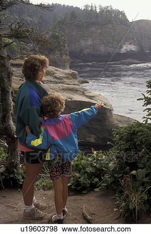 Cape Flattery, Washington, Olympic Peninsula, Pacific Ocean, Mother and 6 year old daughter look at the view from Cape Flattery, the Northwesternmost point in the Continuous United States in the state of Washington. View Large Photo Image Stock Photo - Cape Flattery, Washington, Olympic Peninsula, Pacific Ocean, Mother and 6 year old daughter look at the view from Cape Flattery, the Northwesternmost point in the Continuous United States in the state of Washington. . Fotosearch