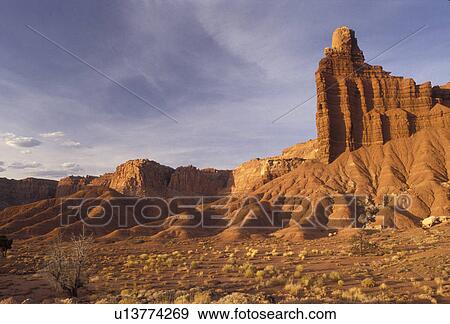 Capitol Reef, Capitol Reef National Park, Utah, Chimney Rock a natural rock formation stands across a red dusty valley with rolling mountains in Capitol Reef Nat'l Park in the state of Utah. View Large Photo Image Stock Photo - Capitol Reef, Capitol Reef National Park, Utah, Chimney Rock a natural rock formation stands across a red dusty valley with rolling mountains in Capitol Reef Nat'l Park in the state of Utah.. Fotosearch