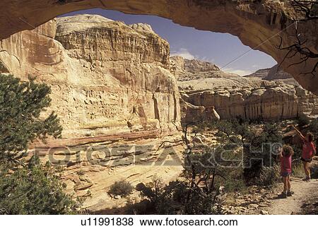 Capitol Reef, hiking, natural bridge, Capitol Reef National Park, Utah, Mother and daughter (6 years old) admire the natural Hickman Bridge rock formation in Capitol Reef Nat'l Park in the state of Utah. View Large Photo Image Stock Photo - Capitol Reef, hiking, natural bridge, Capitol Reef National Park, Utah, Mother and daughter (6 years old) admire the natural Hickman Bridge rock formation in Capitol Reef Nat'l Park in the state of Utah.. Fotosearch