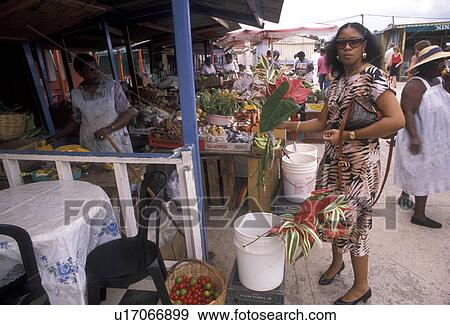 Caribbean, street market, St. Martin, Marigot, Caribbean Islands, Local woman buying flowers at a street market in Marigot the French capital of the island of Saint Martin (french part). View Large Photo Image Stock Photo - Caribbean, street market, St. Martin, Marigot, Caribbean Islands, Local woman buying flowers at a street market in Marigot the French capital of the island of Saint Martin (french part).. Fotosearch
