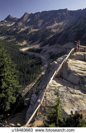 Cascades, Cascade Range, Washington, Washington Pass, Hikers at overlook at Washington pass on the Northern Cascade Mountains in the state of Washington. Road winds its way up the mountain. View Large Photo Image Stock Image - Cascades, Cascade Range, Washington, Washington Pass, Hikers at overlook at Washington pass on the Northern Cascade Mountains in the state of Washington. Road winds its way up the mountain.. Fotosearch