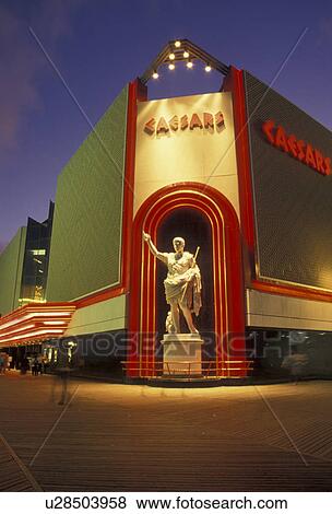 casino, Atlantic City, Caesars, New Jersey, Caesars Casino Hotel on the boardwalk in Atlantic City illuminated at night in the state of New Jersey. View Large Photo Image Stock Photo - casino, Atlantic City, Caesars, New Jersey, Caesars Casino Hotel on the boardwalk in Atlantic City illuminated at night in the state of New Jersey. . Fotosearch