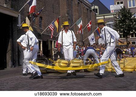 cheese market, Alkmaar, Netherlands, Europe, Costumed porters carrying wheels of cheese (Gouda and red-skinned Edam) on a sledge at the weekly Cheese Market on the Waagplein in Alkmaar. View Large Photo Image Stock Photo - cheese market, Alkmaar, Netherlands, Europe, Costumed porters carrying wheels of cheese (Gouda and red-skinned Edam) on a sledge at the weekly Cheese Market on the Waagplein in Alkmaar.. Fotosearch