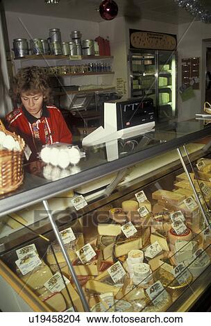 cheese shop, cheese, store, Switzerland, a woman stands behind the counter of a dairy case of assorted cheeses in a cheese shop in Affoltern in the Canton of Bern in the country of Switzerland. View Large Photo Image Picture - cheese shop, cheese, store, Switzerland, a woman stands behind the counter of a dairy case of assorted cheeses in a cheese shop in Affoltern in the Canton of Bern in the country of Switzerland.. Fotosearch
