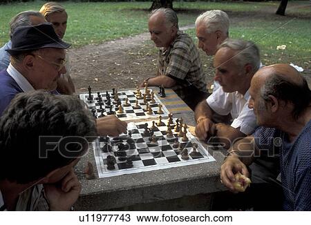 Stock Image -  chess game, Budapest, Hungary, Europe, Local men playing games of chess in a park in the capital city of Budapest.. Fotosearch