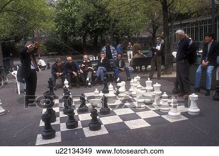 Stock Photo -  Chess, Geneva, Switzerland, Europe, Men playing a giant game of outdoor chess at the Promenade des Bastions in the city of Geneva in the Canton of Geneva. . Fotosearch