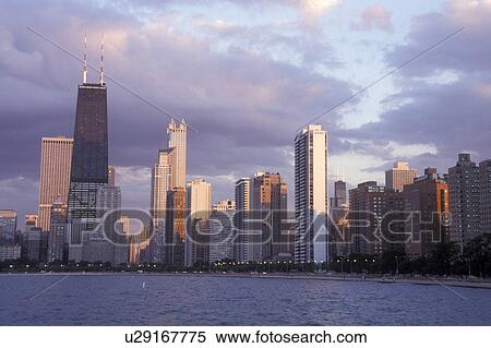 Chicago, Illinois, skyline of downtown Chicago from the waters of Lake Michigan at sunset View Large Photo Image Stock Photography - Chicago, Illinois, skyline of downtown Chicago from the waters of Lake Michigan at sunset . Fotosearch