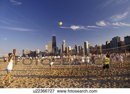 Chicago, volleyball, skyline, Illinois, People playing volleyball games on the beach along Lake Michigan at North Avenue Park with skyline of downtown Chicago in the background in the state of Illinois. View Large Photo Image Stock Photo - Chicago, volleyball, skyline, Illinois, People playing volleyball games on the beach along Lake Michigan at North Avenue Park with skyline of downtown Chicago in the background in the state of Illinois. . Fotosearch