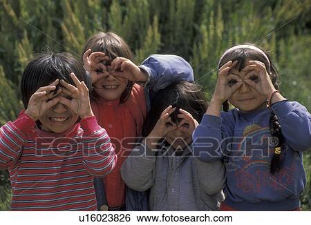 Stock Photograph -  children, Patagonia, Tierra del Fuego, Argentina, Ushuaia, Andes, Children make funny faces with their fingers in the world's southernmost town of Ushuaia in Argentina. . Fotosearch