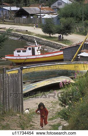 Picture -  Chile, Young girl running with a ball through the fishing village of Amargos in the South-Central Region in Chile. . Fotosearch