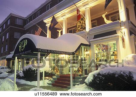 Stock Photo -  Christmas, hotel, Inn, Vermont, winter, Montpelier, The snow covered Capitol Plaza Hotel with Christmas decorations at night in Montpelier in Washington County in the state of Vermont. . Fotosearch