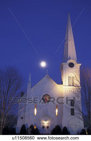 Stock Image -  church, Vermont, moon, winter, Christmas, Full moon rises over the First Congregational Church at night in the winter in Manchester Village in Bennington County in the state of Vermont. New England style church. Fotosearch