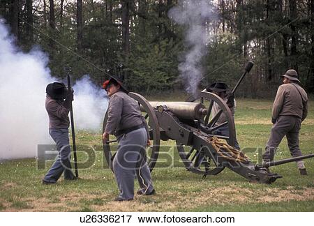Stock Photo -  Civil War reenactment, canon, Atlanta, Georgia's Stone Mountain Park, Georgia, Men dressed as Confederate Soldiers fire a cannon during a Civil War Reenactment at the Antebellum Jubilee at Stone Mountain Park in Atlanta in the state of Georgia. . Fotosearch