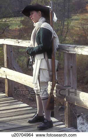 Picture -  Concord, Massachusetts, A Minute Man Interpreter holds The Smoothbore Musket on the North Bridge at the Minute Man National Historic Site., . Fotosearch