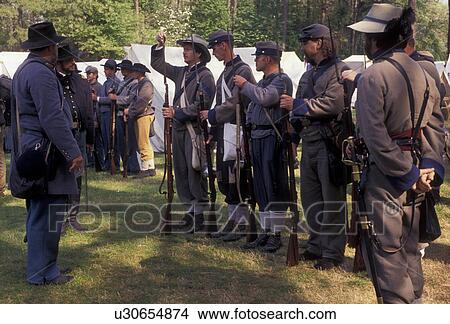 Picture -  Confederate soldiers, Civil War Reenactment, Confederate, Stone Mountain, Atlanta, Georgia's Stone Mountain Park, Georgia, Men dressed as Confederate Soldiers prepare muskets (rifles) for firing during a Civil War Reenactment at the Antebellum Jubilee at. Fotosearch