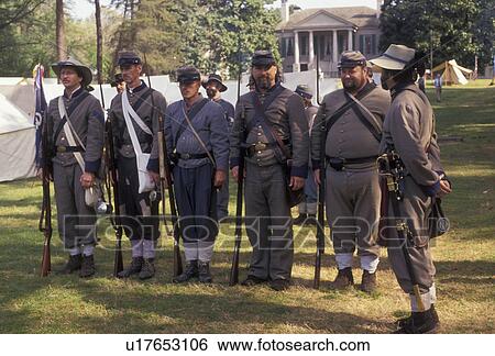 Stock Photograph -  Confederate soldiers, War reenactment, confederate, Stone Mountain, Atlanta, Georgia's Stone Mountain Park, Georgia, Men dressed as Confederate Soldiers stand at attention waiting for commands from officer during a Civil War Reenactment at the Antebellum. Fotosearch