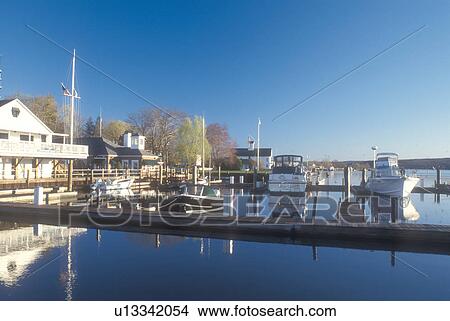 Picture -  Connecticut, marina, Boats docked at a marina reflect in the calm waters of the Connecticut River in Essex, Connecticut.. Fotosearch