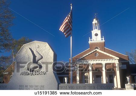 Stock Photography -  Connecticut, Town Hall, war memorial, and U. S. Flag in Clinton, Connecticut.. Fotosearch