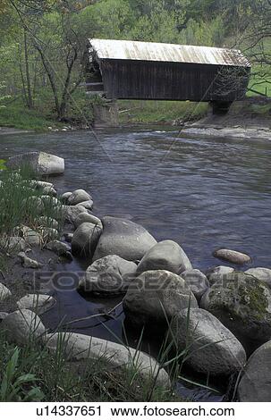 Stock Image -  covered bridge, river, Vermont, VT, The Flint Covered Bridge, ca. 1845, crosses over the First Branch White River in Tunbridge in the spring. . Fotosearch