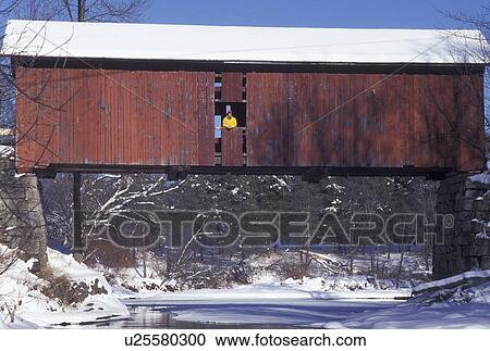 covered bridge, winter, Vermont, A woman stands in the window of The Slaughter House Covered Bridge which crosses over the frozen waters of the Dog River on a winter day in Northfield Falls in Washington County in the state of Vermont. View Large Photo Image Stock Image - covered bridge, winter, Vermont, A woman stands in the window of The Slaughter House Covered Bridge which crosses over the frozen waters of the Dog River on a winter day in Northfield Falls in Washington County in the state of Vermont.. Fotosearch