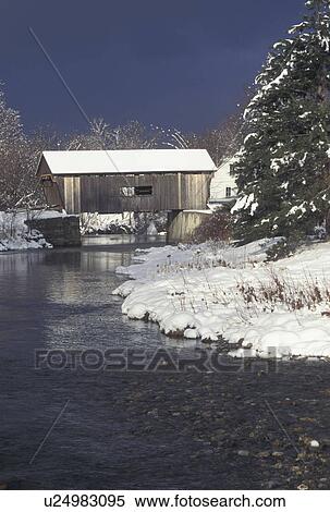 Stock Photography -  covered bridge, winter, Vermont, Warren Covered Bridge c. 1880 crosses over the Mad River in Warren in Mad River Valley in Washington County in the state of Vermont.. Fotosearch