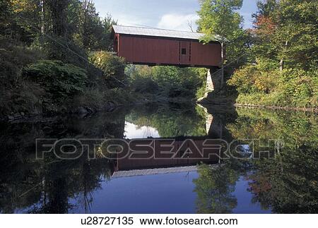 Stock Photography -  covered bridge, wooden bridge, fall, reflection, Vermont, The Slaughter House Covered Bridge reflects in the calm waters of the Dog River in Northfield Falls in Washington County in the state of Vermont in early autumn.. Fotosearch