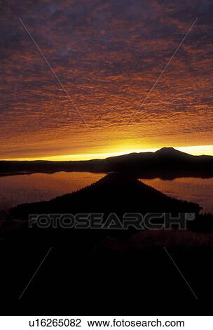 Stock Image -  Crater Lake, sunrise, silhouette, Crater Lake National Park, Cascade Range, Cascade Mountains, Oregon, Crater Lake at sunrise in Crater Lake Nat'l Park in the state of Oregon. . Fotosearch