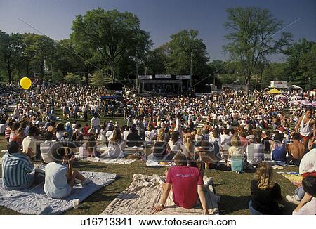 Stock Image -  crowd, concert, people, Georgia, A crowd of people sitting on the lawn listening to the Turtles Concert at the Dogwood Festival in Piedmont Park in Atlanta. . Fotosearch
