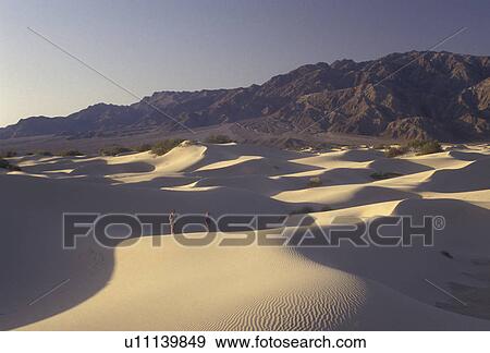 Death Valley, Death Valley National Park, sand dunes, Mojave Desert, California, Mother and daughter walk on the sand dunes in the early morning with the Panamint Mountains in the distance in Death Valley Nat'l Park in the state of California. View Large Photo Image Stock Photo - Death Valley, Death Valley National Park, sand dunes, Mojave Desert, California, Mother and daughter walk on the sand dunes in the early morning with the Panamint Mountains in the distance in Death Valley Nat'l Park in the state of California.. Fotosearch