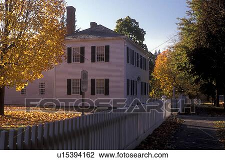 Stock Image -  Deerfield, Massachusetts, A colonial house with a white picket fence in Historic Deerfield in the fall . Fotosearch