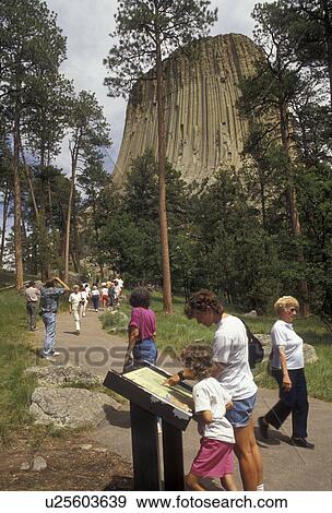 Devils Tower, Devils Tower National Monument, Wyoming, People walk up the Tower Trail to view the spectacular Devils Tower National Monument in the state of Wyoming. Mother and daughter reading informative sign about Devils Tower. View Large Photo Image Stock Photo - Devils Tower, Devils Tower National Monument, Wyoming, People walk up the Tower Trail to view the spectacular Devils Tower National Monument in the state of Wyoming. Mother and daughter reading informative sign about Devils Tower.. Fotosearch