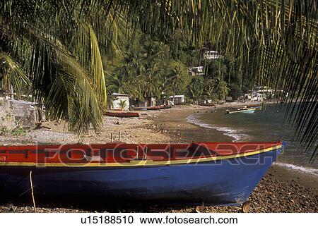 Dominica, Caribbean, Caribbean Islands, Colorful blue, yellow and red fishing boat on the beach in Soufriere on the island of Dominica. View Large Photo Image Stock Image - Dominica, Caribbean, Caribbean Islands, Colorful blue, yellow and red fishing boat on the beach in Soufriere on the island of Dominica.. Fotosearch