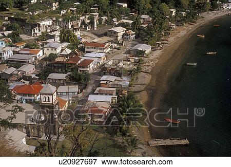 Stock Photo -  Dominica, Caribbean, Caribbean Islands, Aerial view of beachfront houses in Soufriere on the island of Dominica.. Fotosearch