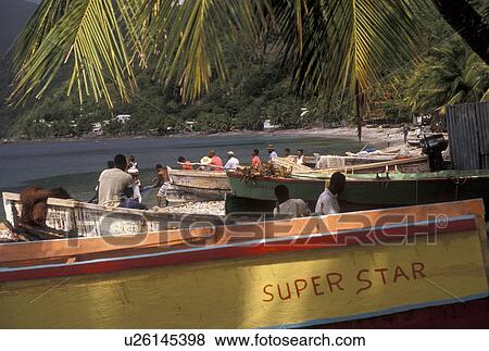 Stock Photo -  Dominica, Caribbean, Caribbean Islands, Local fishermen working in boats on the beach at Scotts Head on the island of Dominica.. Fotosearch