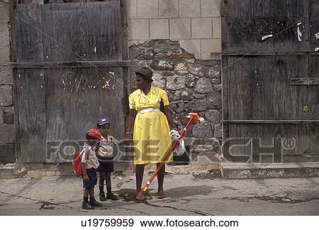 Dominica, Caribbean, Roseau, Caribbean Islands, Local black woman and her two sons walking to school in downtown Roseau the capital of the island of Dominica. View Large Photo Image Stock Photo - Dominica, Caribbean, Roseau, Caribbean Islands, Local black woman and her two sons walking to school in downtown Roseau the capital of the island of Dominica.. Fotosearch