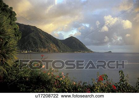 Dominica, island, paradise, Caribbean, Roseau, Caribbean Islands, Sunset along the scenic coast of the Caribbean Sea with its volcanic mountain range of the island of Dominica. View Large Photo Image Stock Image - Dominica, island, paradise, Caribbean, Roseau, Caribbean Islands, Sunset along the scenic coast of the Caribbean Sea with its volcanic mountain range of the island of Dominica.. Fotosearch