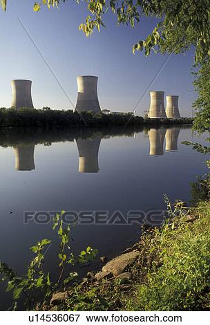 Stock Photo -  energy, nuclear, Three Mile Island, power, nuclear power plant, Pennsylvania, Three Mile Island Nuclear Power Plant cooling towers reflect in the calm water of the Susquehanna River in Middletown in the state of Pennsylvania. Sight of the 1979 radioactiv. Fotosearch