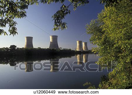 Stock Photo -  energy, Three Mile Island, nuclear power, electricity, Pennsylvania, Three Mile Island Nuclear Power Plant, Cooling towers reflect in the calm water of the Susquehanna River in Middletown in the state of Pennsylvania. Site of the 1979 radioactive nuclear. Fotosearch