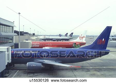 Stock Photograph -  England, London, airport, Heathrow Airport Terminal in London. Planes at gates.. Fotosearch