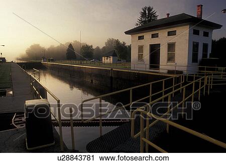 Stock Image -  Erie Canal, Lock, sunrise, Upstate, New York, Sunrise on the Erie Canal at Lock 21 in the state of New York.. Fotosearch