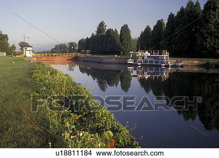 Erie Canal, Lock, Upstate, New York, Reflection on the calm waters of the Erie Canal at Lock 21 in the state of New York. View Large Photo Image Picture -  Erie Canal, Lock, Upstate, New York, Reflection on the calm waters of the Erie Canal at Lock 21 in the state of New York.. Fotosearch