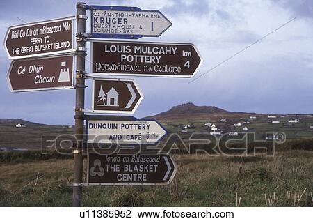 Stock Image -  Europe, Republic of Ireland, Ireland, Dingle Pininsula, direction signs, English & Gaelic road signs in County Kerry.. Fotosearch