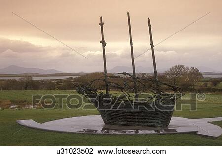 Europe, Republic of Ireland, Ireland, Potato Famine Memorial shaped like an old ship is displayed in a lush green field of Westport in County Mayo. View Large Photo Image Stock Image - Europe, Republic of Ireland, Ireland, Potato Famine Memorial shaped like an old ship is displayed in a lush green field of Westport in County Mayo.. Fotosearch