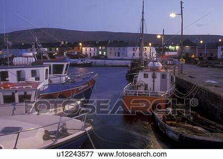 Europe, Republic of Ireland, Ireland, Ring of Kerry, Iveragh, Portmagee, fishing boats docked at harbor in the evening in County Kerry. View Large Photo Image Stock Photo - Europe, Republic of Ireland, Ireland, Ring of Kerry, Iveragh, Portmagee, fishing boats docked at harbor in the evening in County Kerry.. Fotosearch