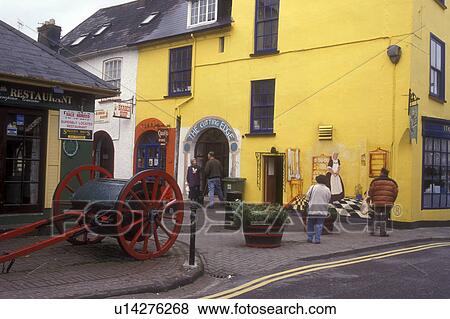 Europe, Republic of Ireland, Ireland, Kinsale, Antique cart is displayed outside colorful shops and restaurants in the picturesque town of Kinsale in County Cork. View Large Photo Image Stock Photo - Europe, Republic of Ireland, Ireland, Kinsale, Antique cart is displayed outside colorful shops and restaurants in the picturesque town of Kinsale in County Cork. . Fotosearch
